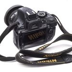 Camera (Nikon Model D5200) with 24 mm. lens (AF Niccor) and strap, used by Bill Cunningham, ca. 2012. (Glenn Castellano, New-York Historical Society)